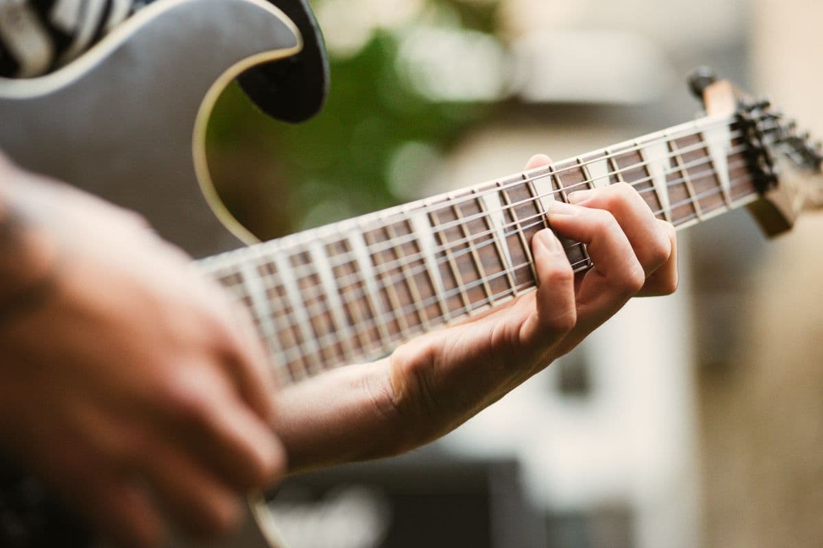 A guitarist's hands on the strings