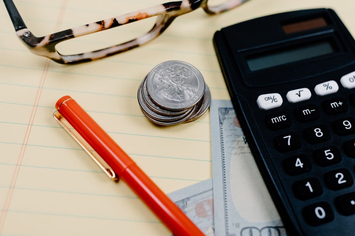 A calculator and coins for budgeting